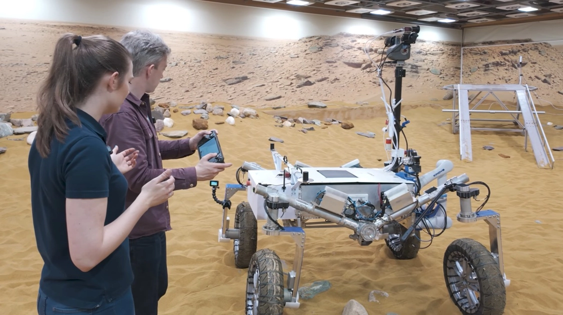 Airbus engineers at the Stevenage facility use a Steam Deck to control the ExoMars rover prototype during ground tests.